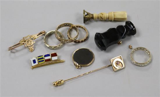 Four assorted 9ct gold and gem set eternity rings, a stick pin, two yellow metal brooches, a hematite pendant and two seals